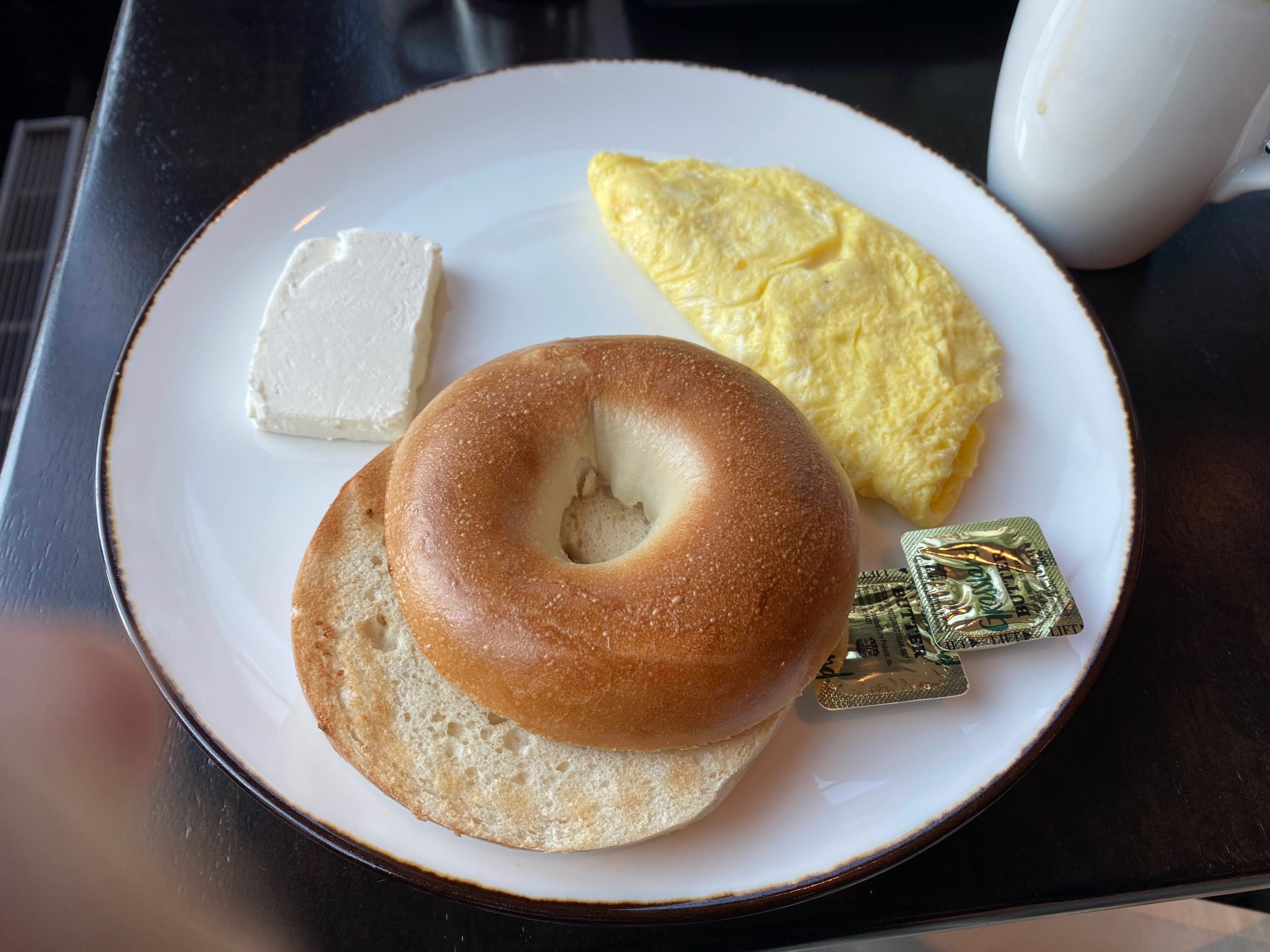 a bagel and eggs on a plate