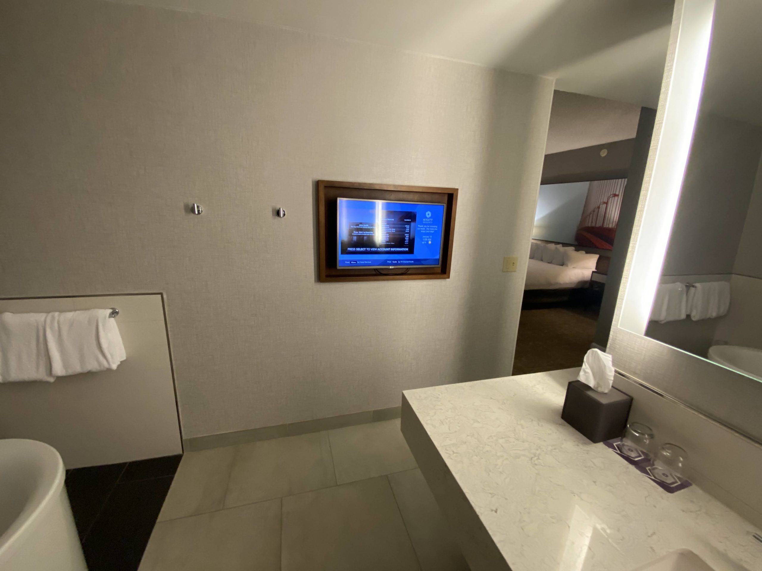 a bathroom with a tv on the wall
