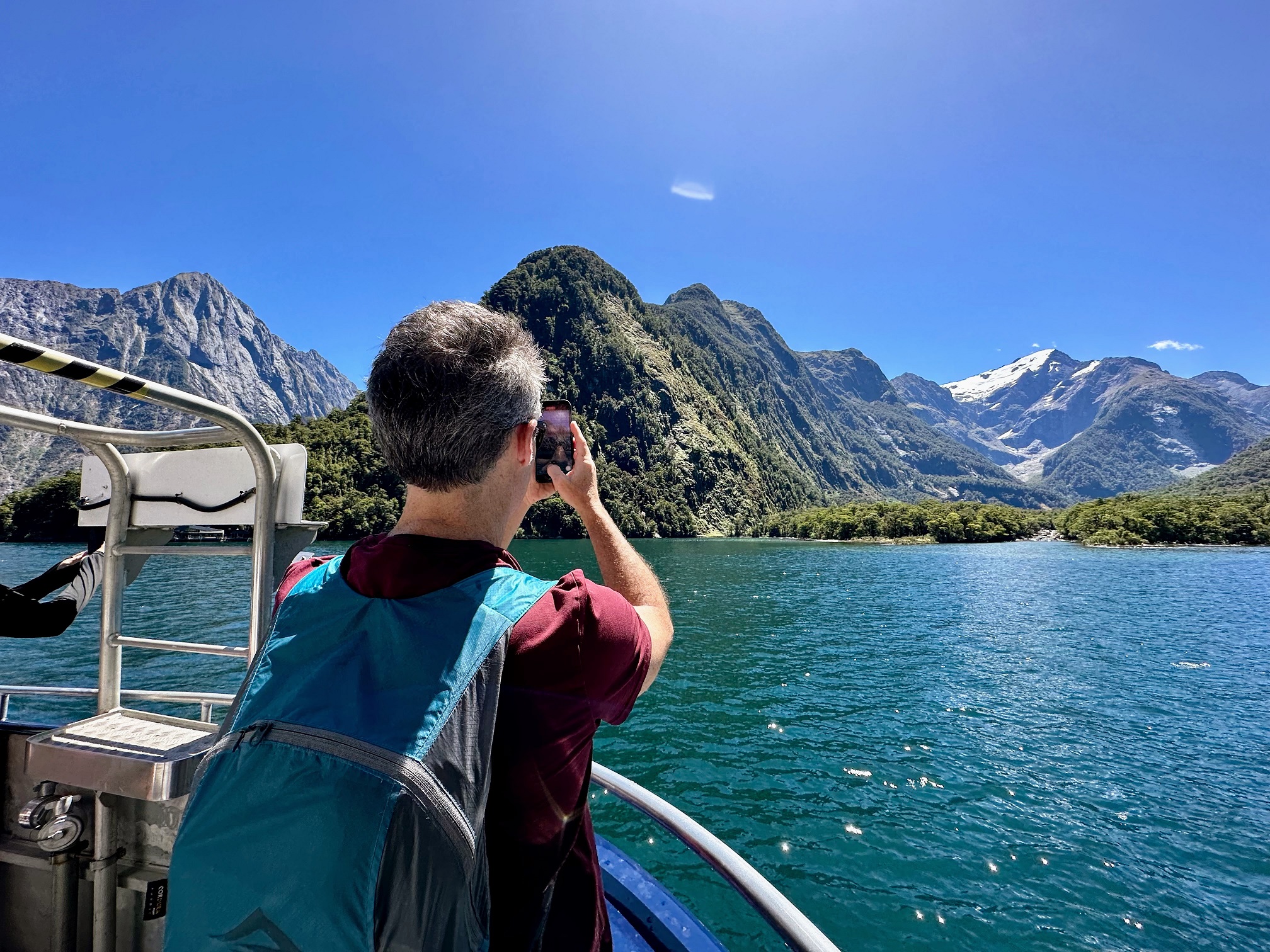 a man taking a picture of a lake