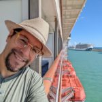 a man taking a selfie on a cruise ship