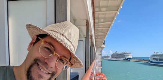 a man taking a selfie on a cruise ship