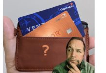 a man with a beard and a wallet with credit cards