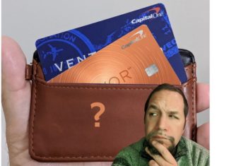 a man with a beard and a wallet with credit cards