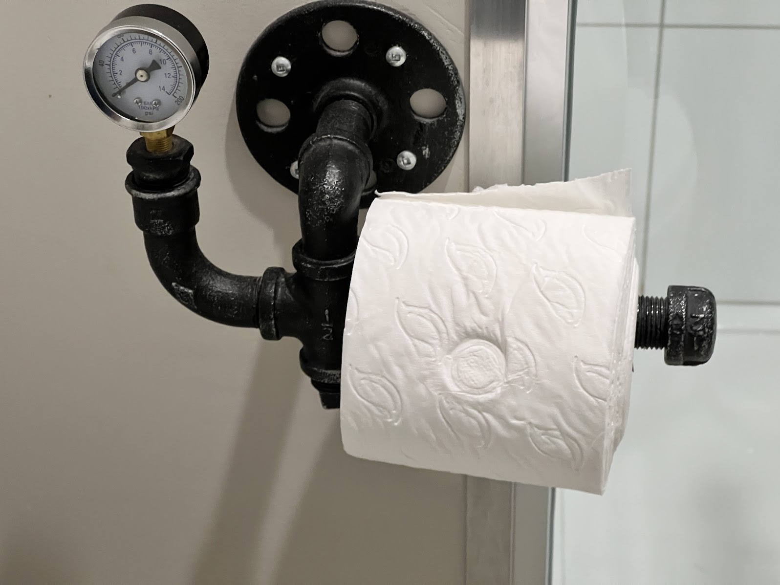 a toilet paper roll on a black pipe