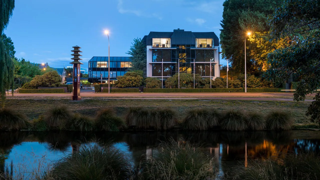 a building with trees and street lights