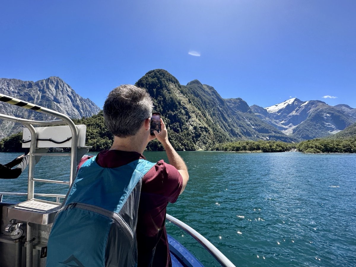 a man taking a picture of a lake