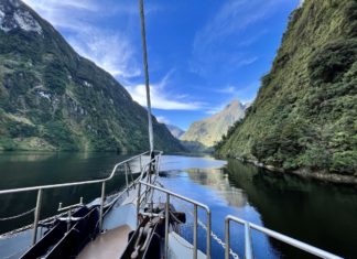 a boat on a river with mountains in the background