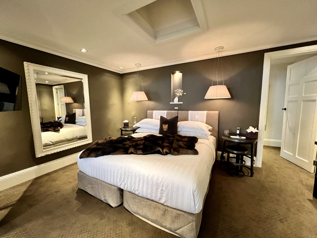a bedroom with a large mirror and a bed