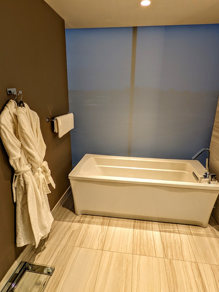 a bathtub and bathrobe in a bathroom