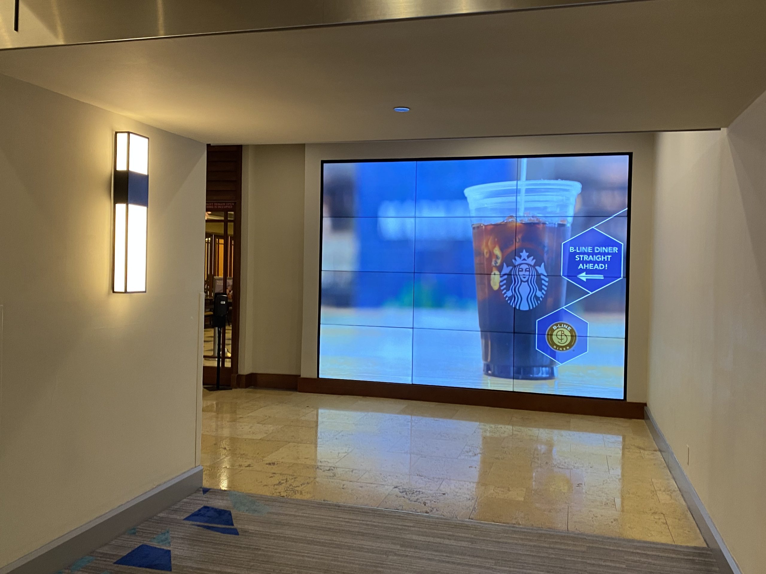 a large screen with a drink on it