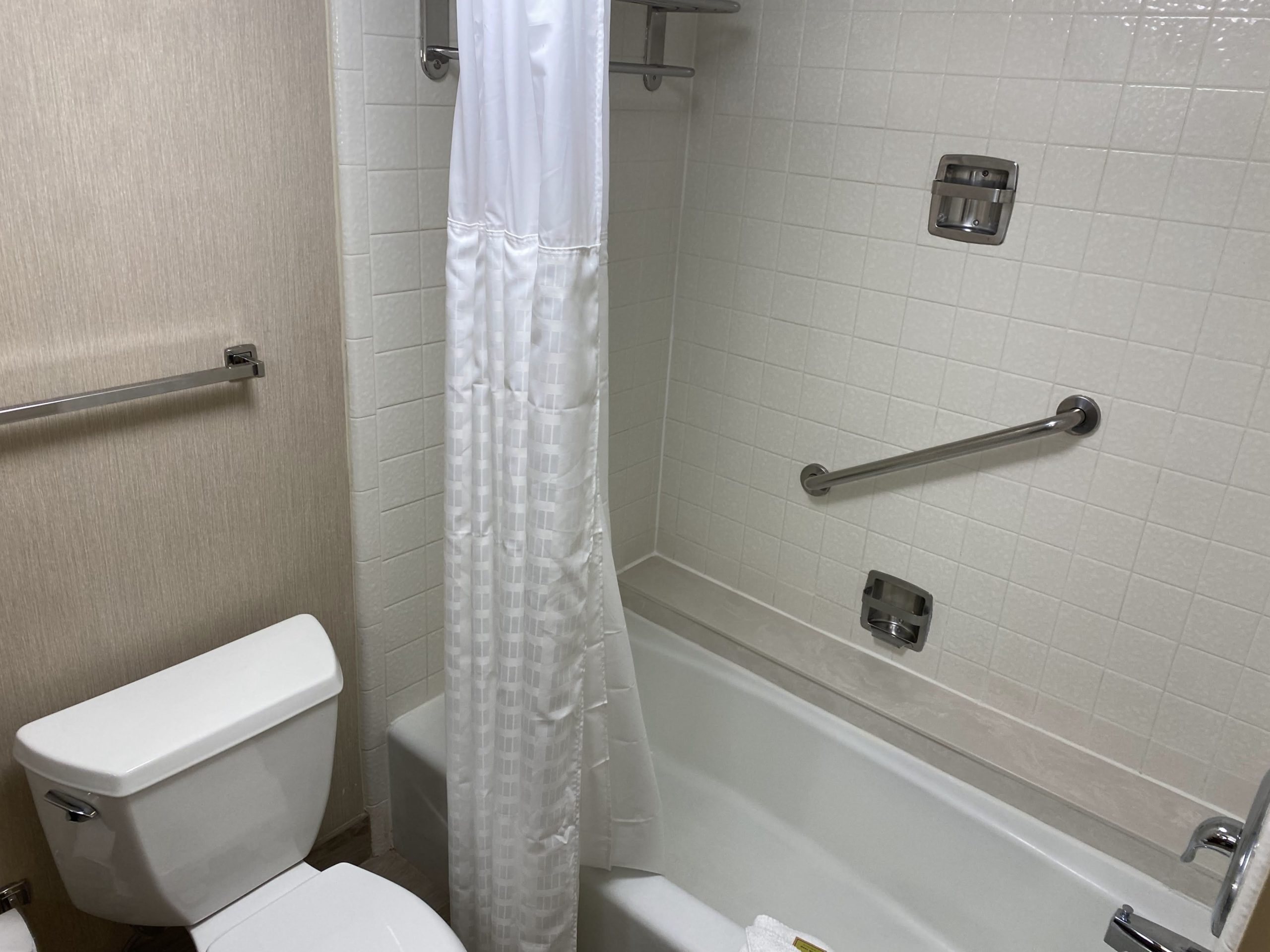 a bathroom with a white shower curtain