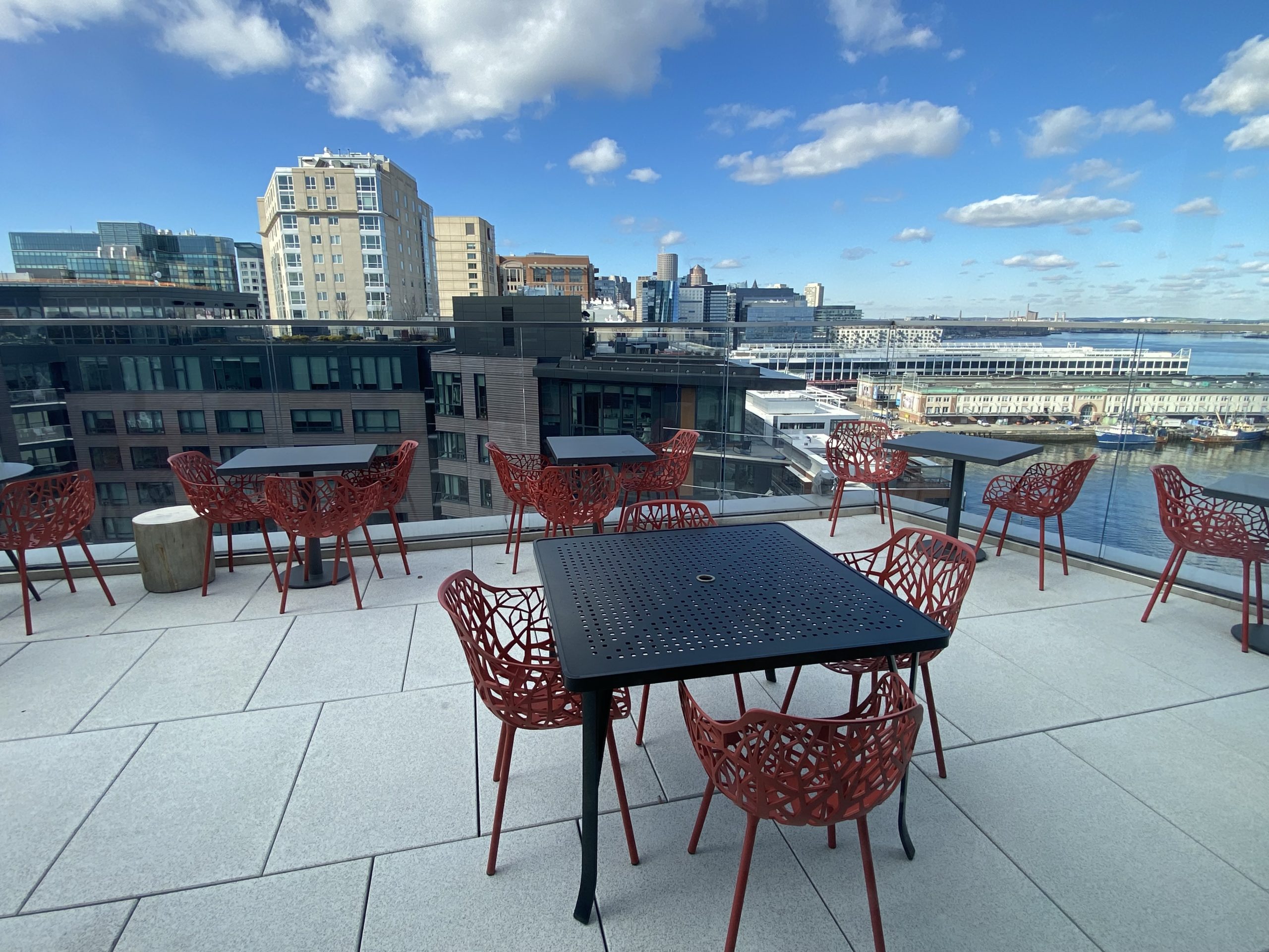 a table and chairs on a rooftop overlooking a city