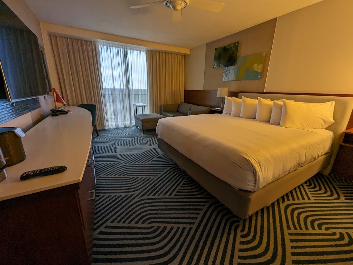 a hotel room with a bed and a desk