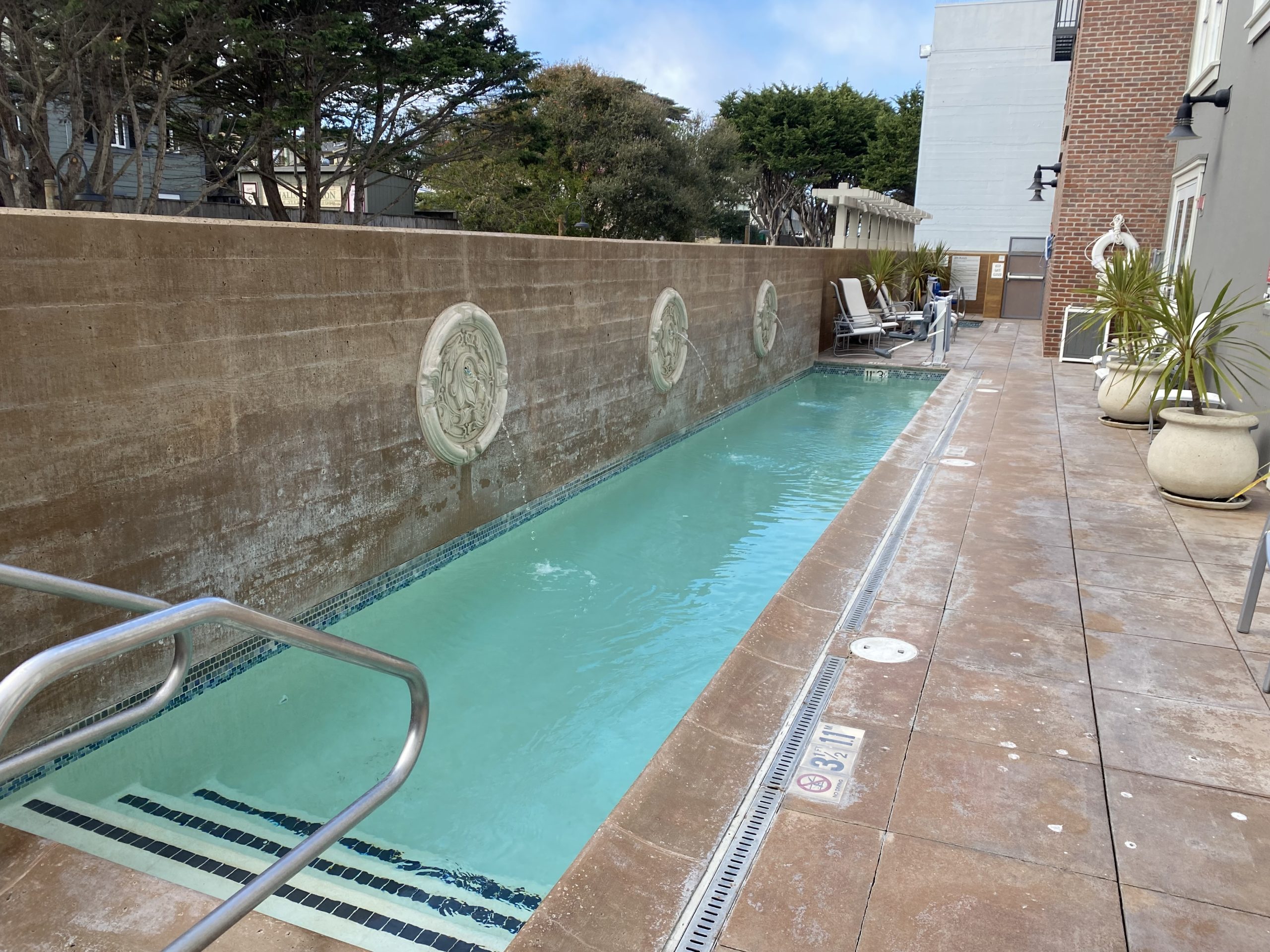 a pool with a wall and a stone wall