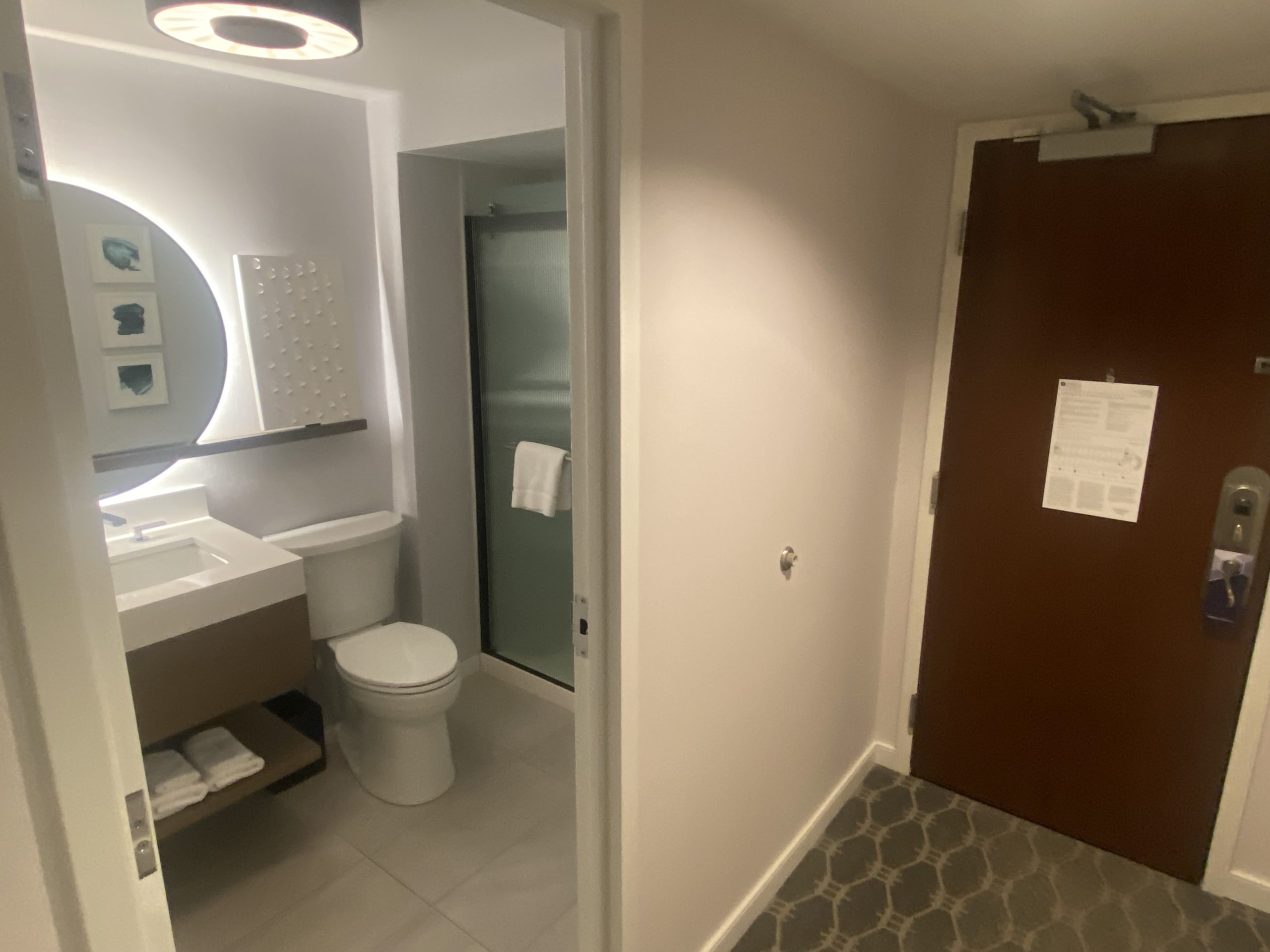 a bathroom with a door and a mirror
