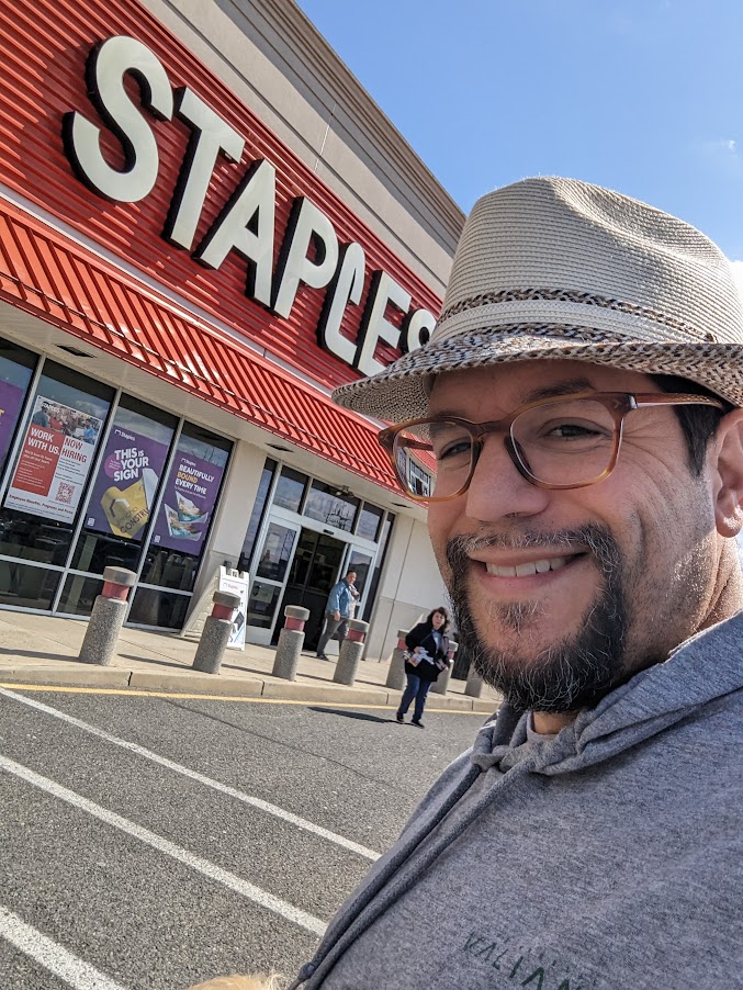 a man taking a selfie in front of a store