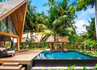 a pool in a house with trees around it