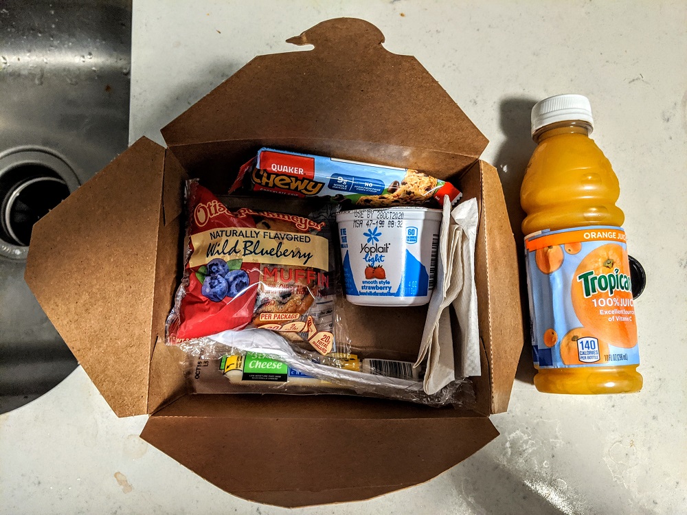 a box of food and a bottle of juice