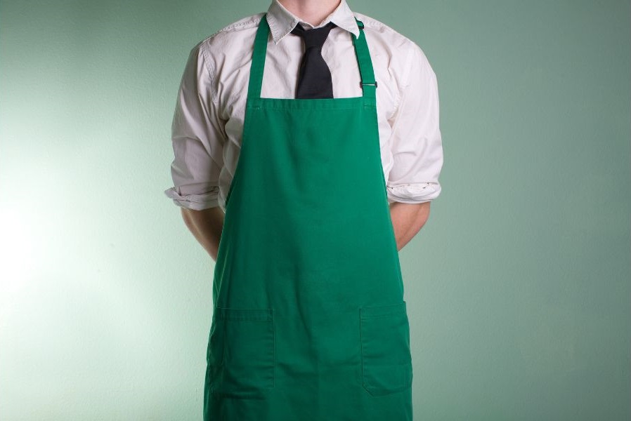 a man wearing a green apron