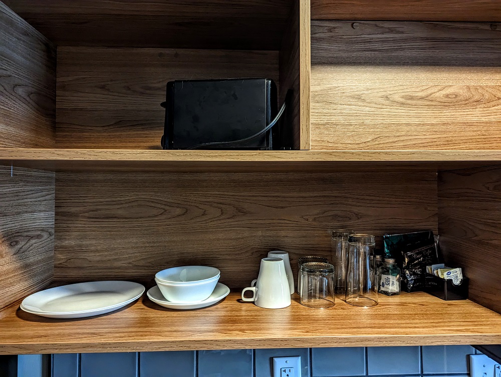 a shelf with plates and glasses on it