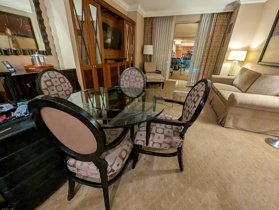 a room with a glass table and chairs