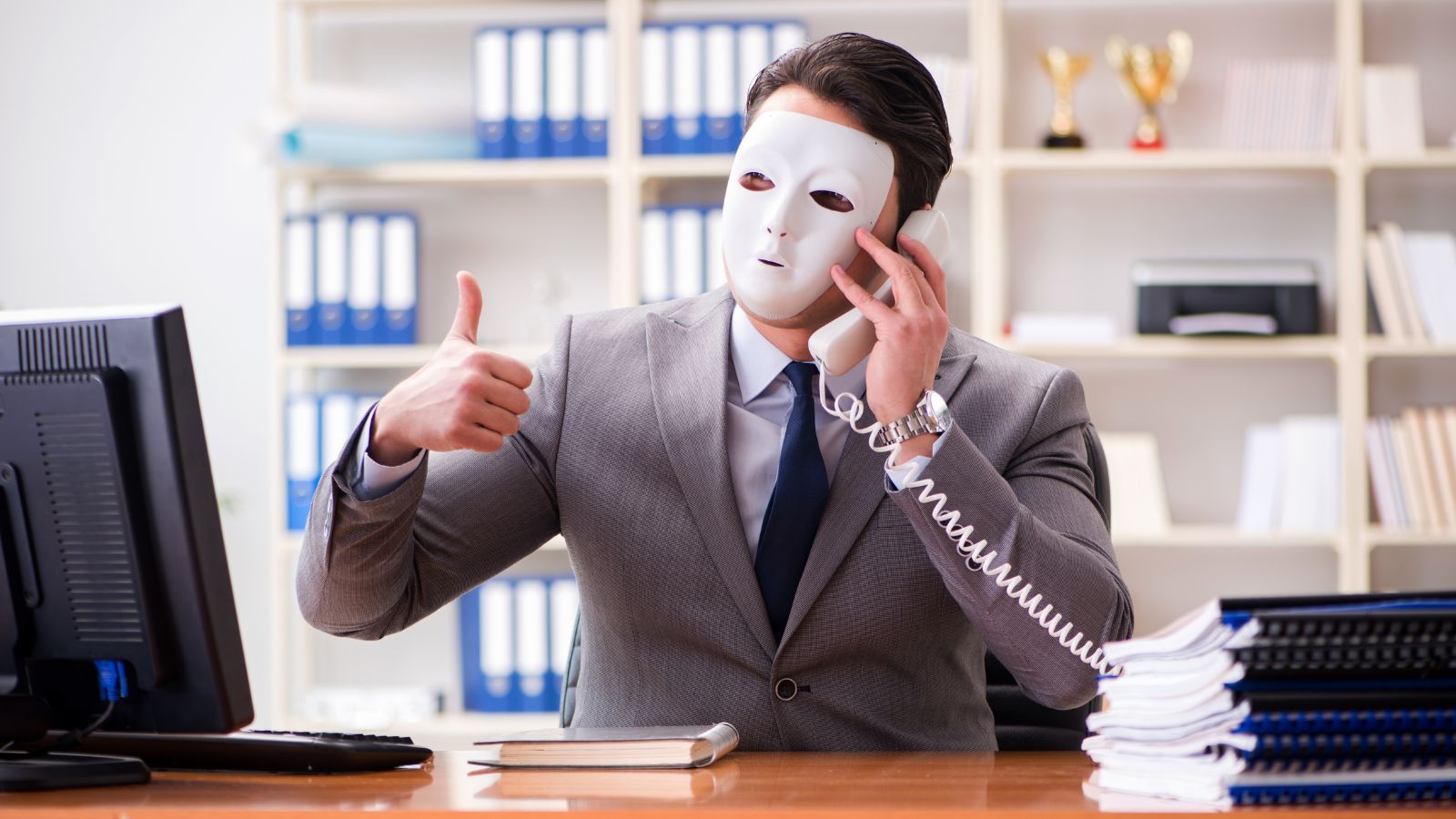 a man wearing a mask and holding a phone
