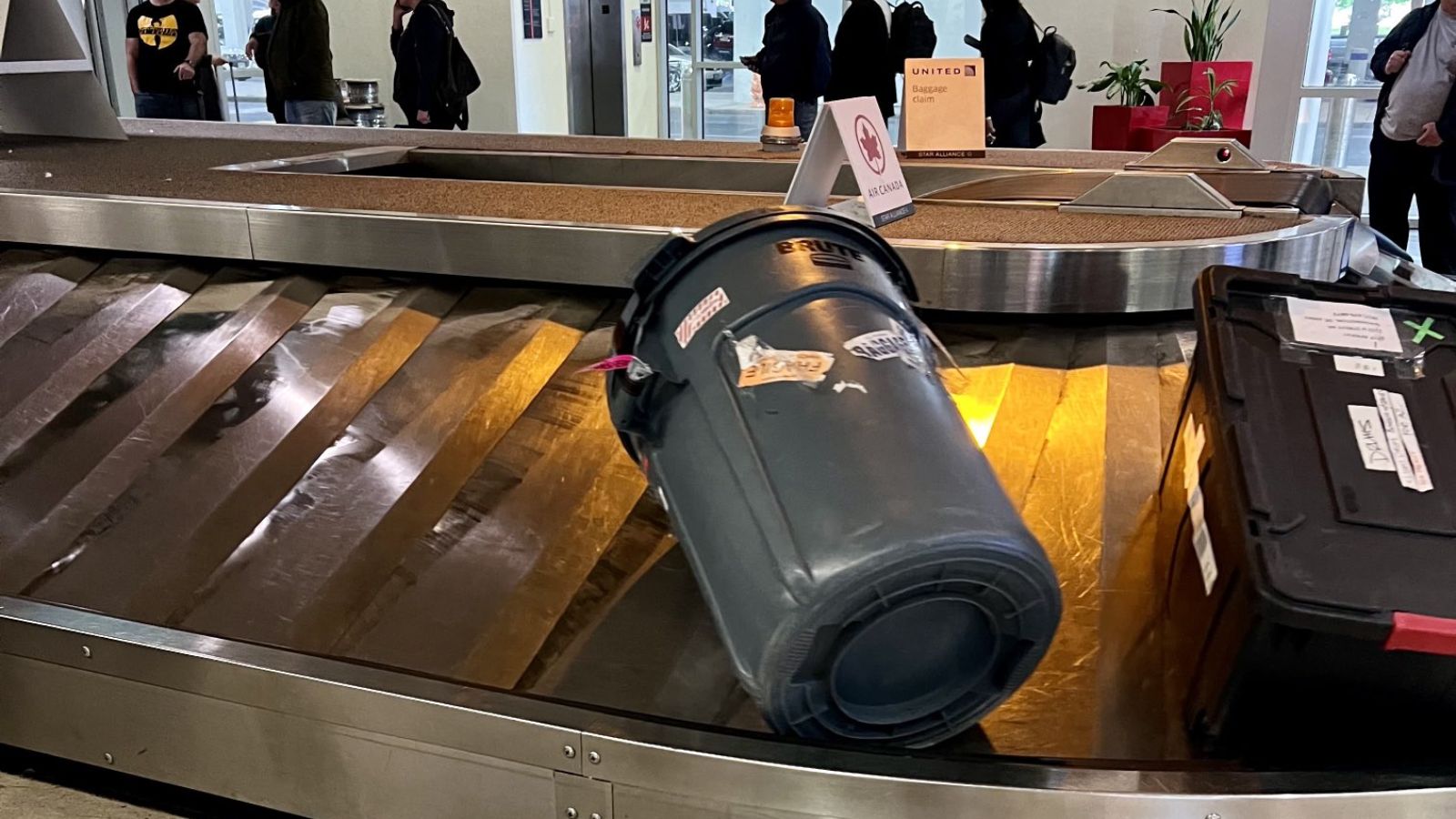 a trash can on a conveyor belt