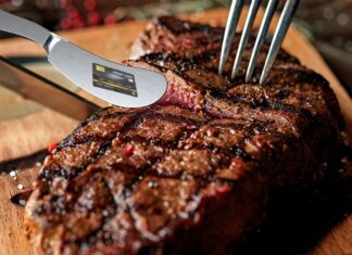 a steak being cut with a knife and fork