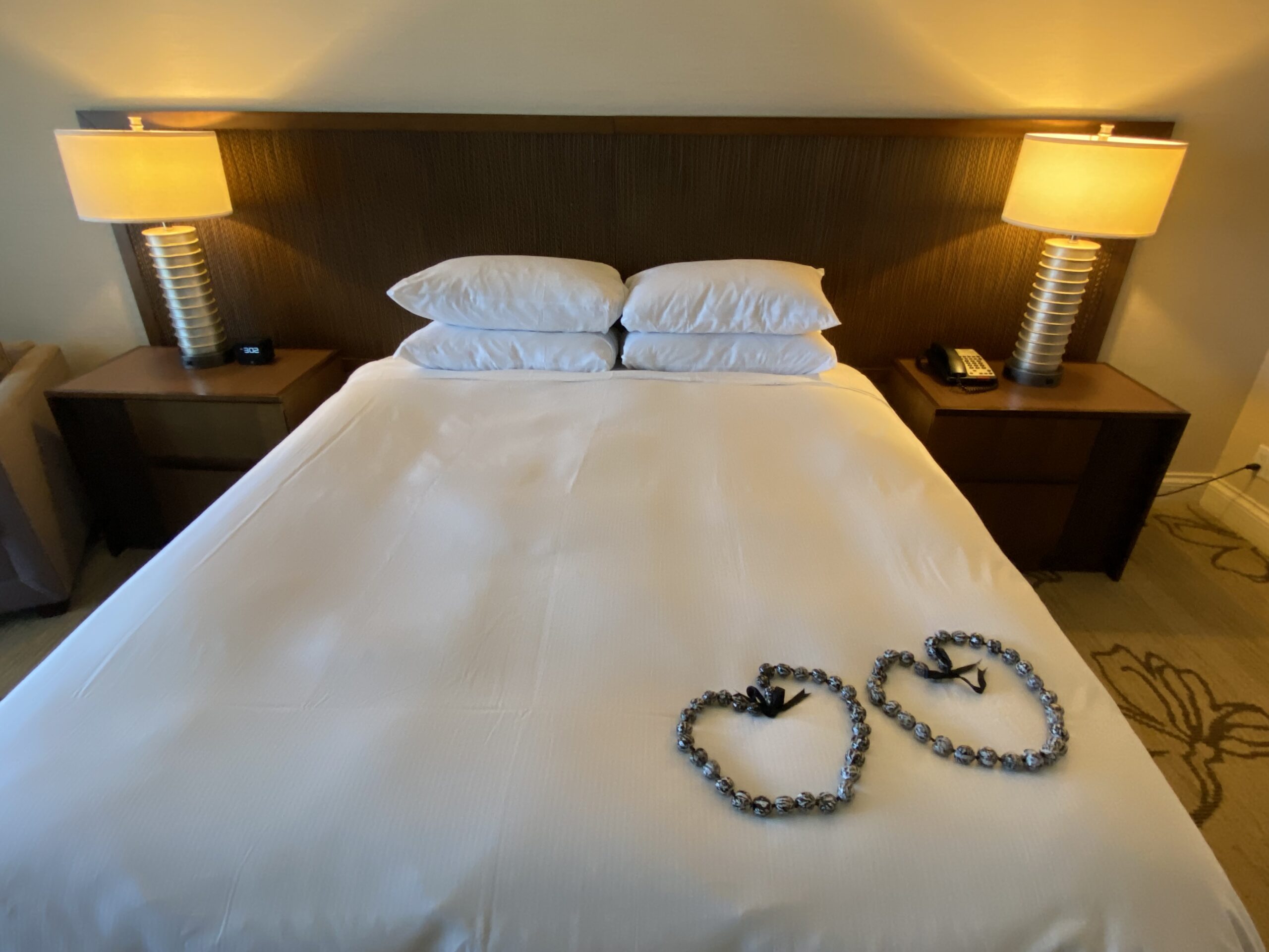 a bed with a couple of heart shaped beads on it