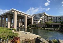 a building with a pond and a large building