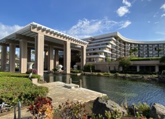 a building with a pond and a large building