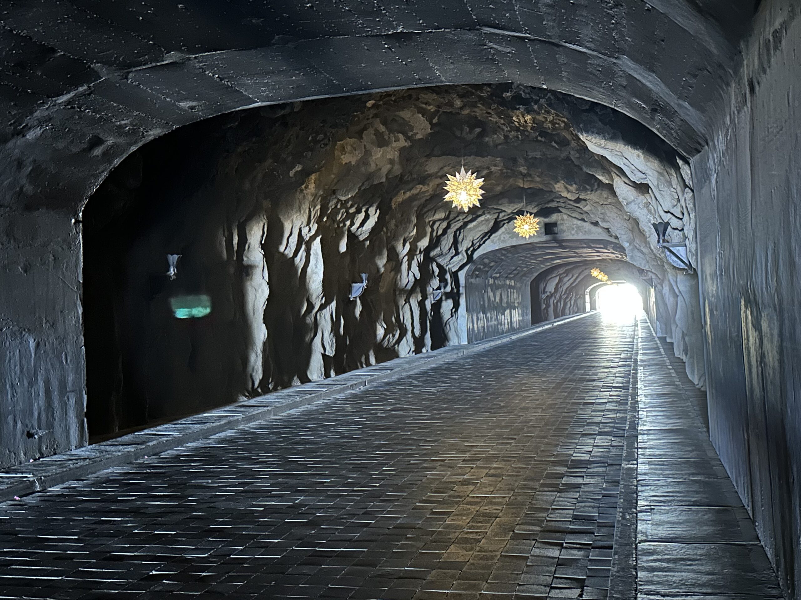a stone tunnel with lights