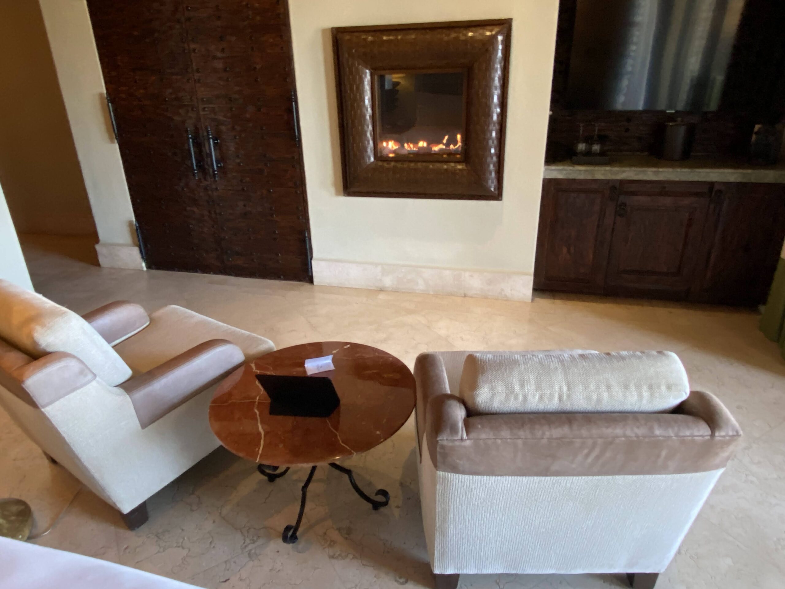 a room with a fireplace and chairs