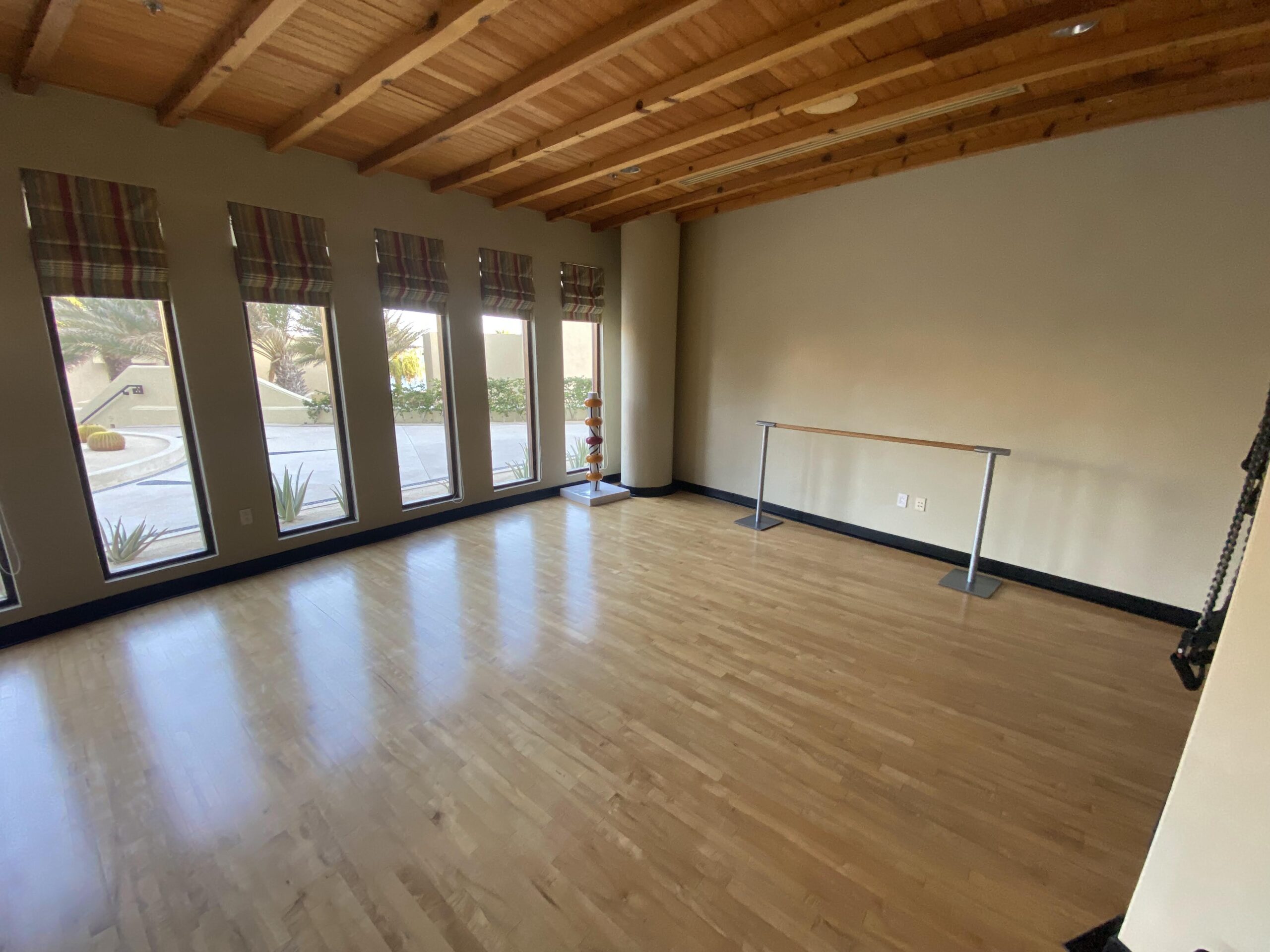 a room with a wooden floor and a pole