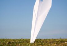 a paper airplane in the grass