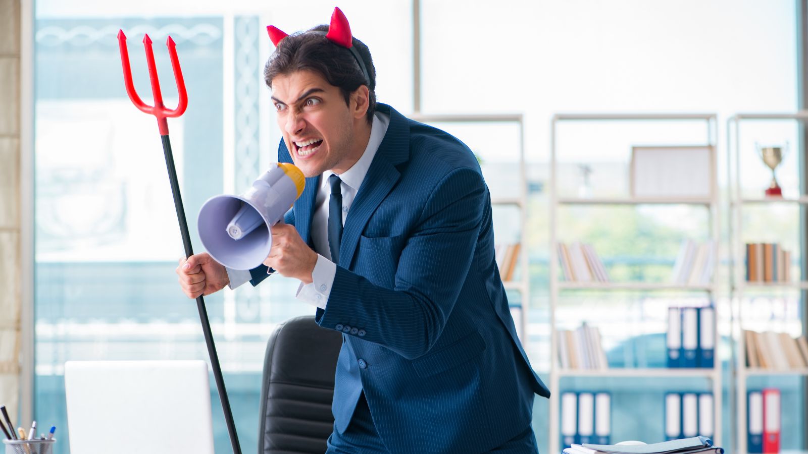 a man in a suit with horns and a megaphone