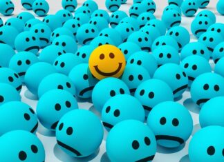 a yellow smiley face in a group of blue balls