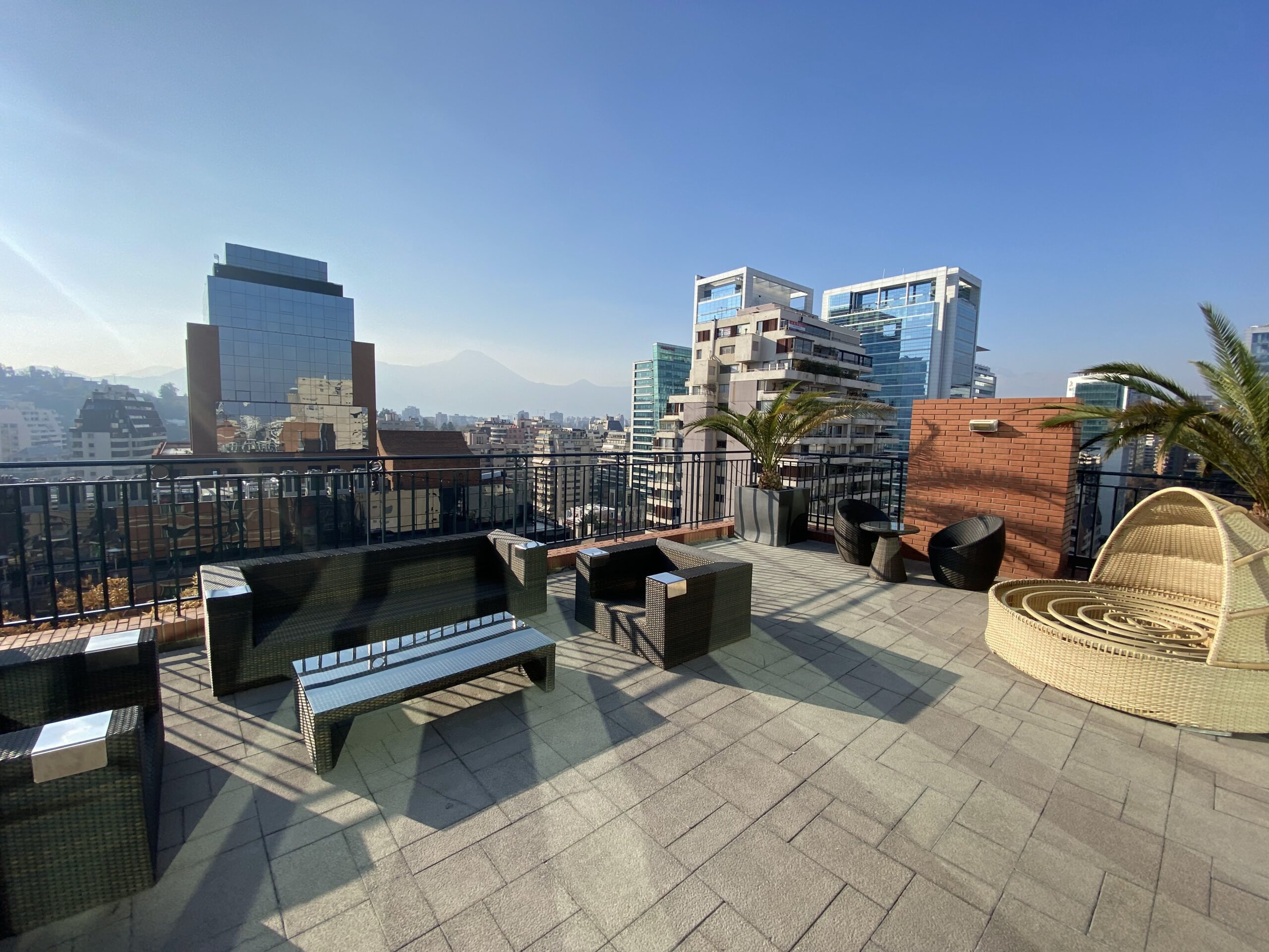 a rooftop patio with a city view