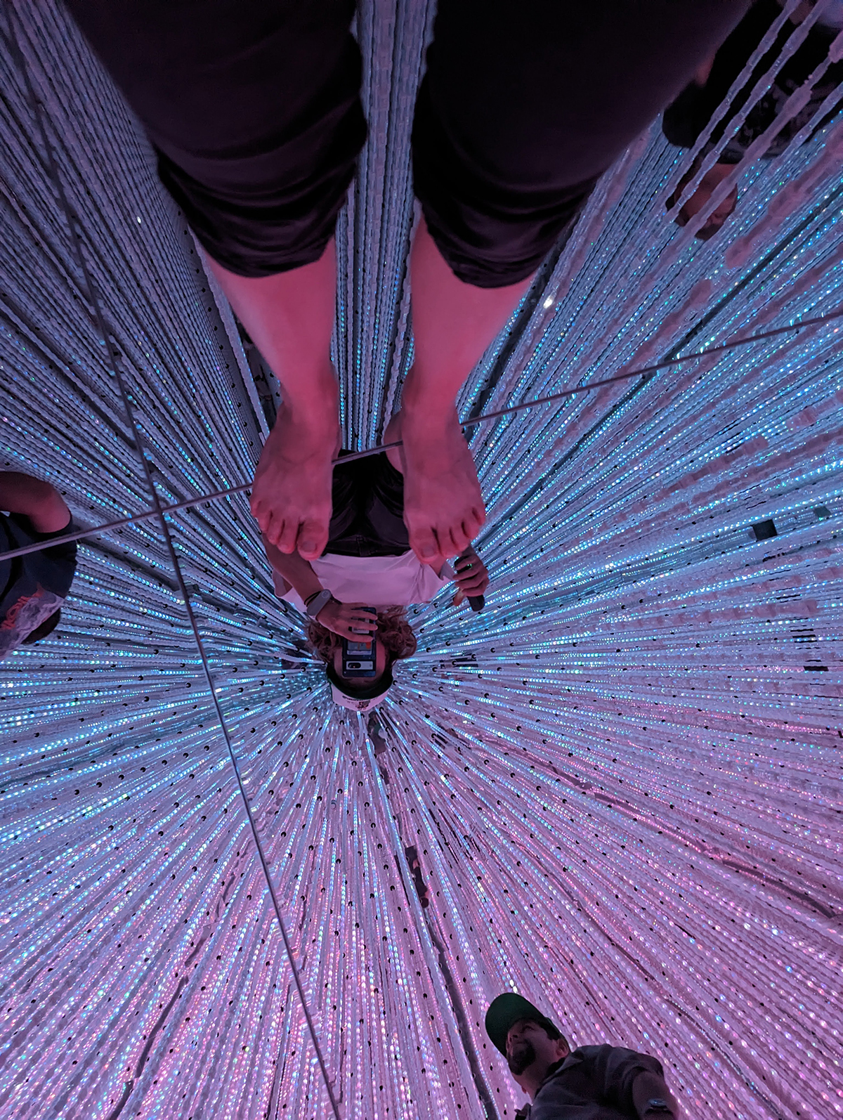 a person standing on a string of lights