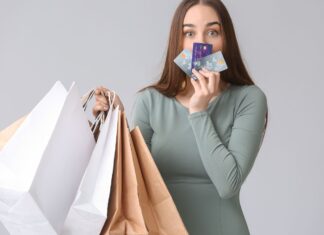a woman holding shopping bags and a credit card