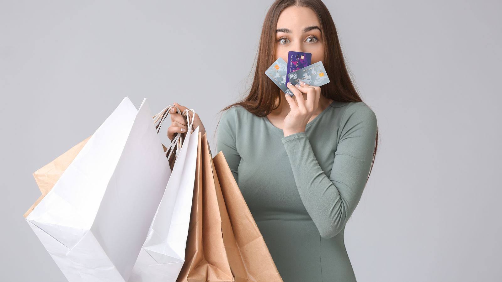 a woman holding shopping bags and a credit card