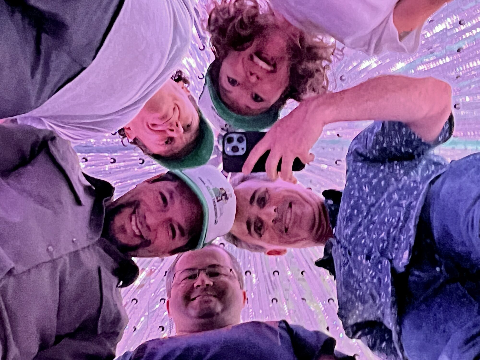 a group of people looking down at the camera