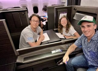 a group of people sitting at a table in a plane