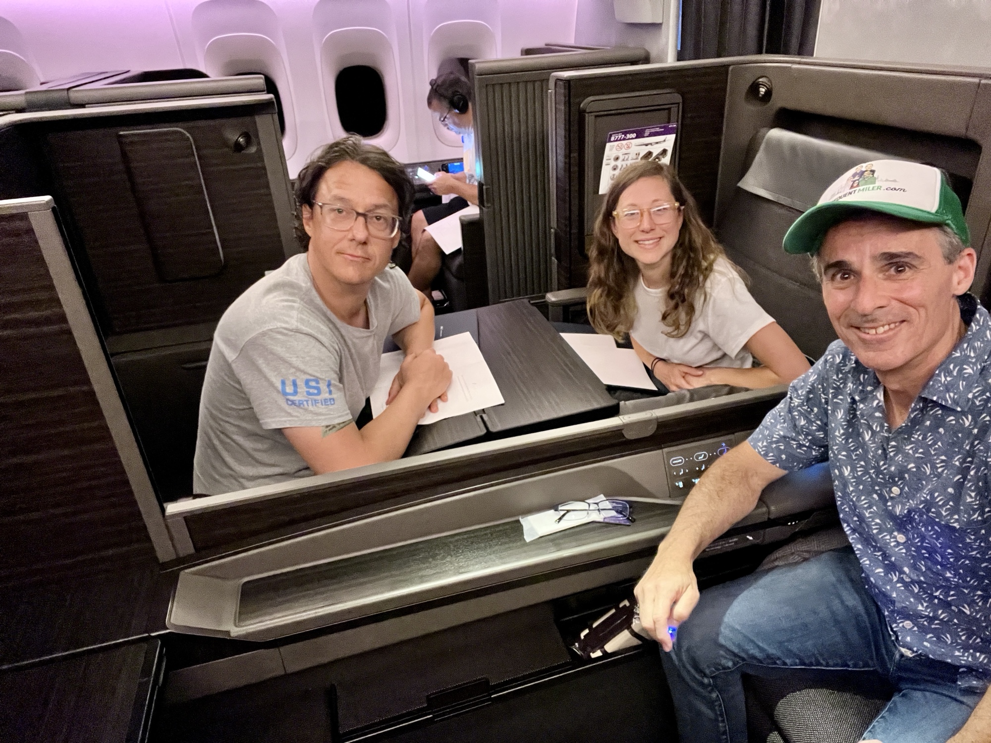 a group of people sitting at a table in a plane
