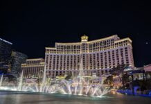 a water fountains in front of a large building with Bellagio in the background
