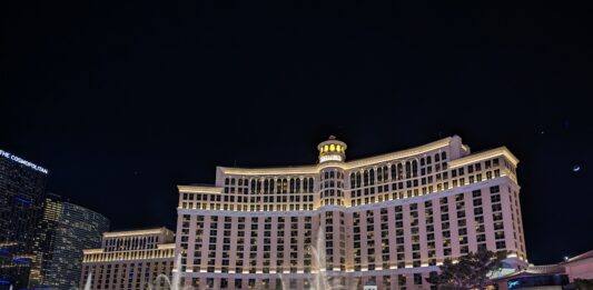 a water fountains in front of a large building with Bellagio in the background
