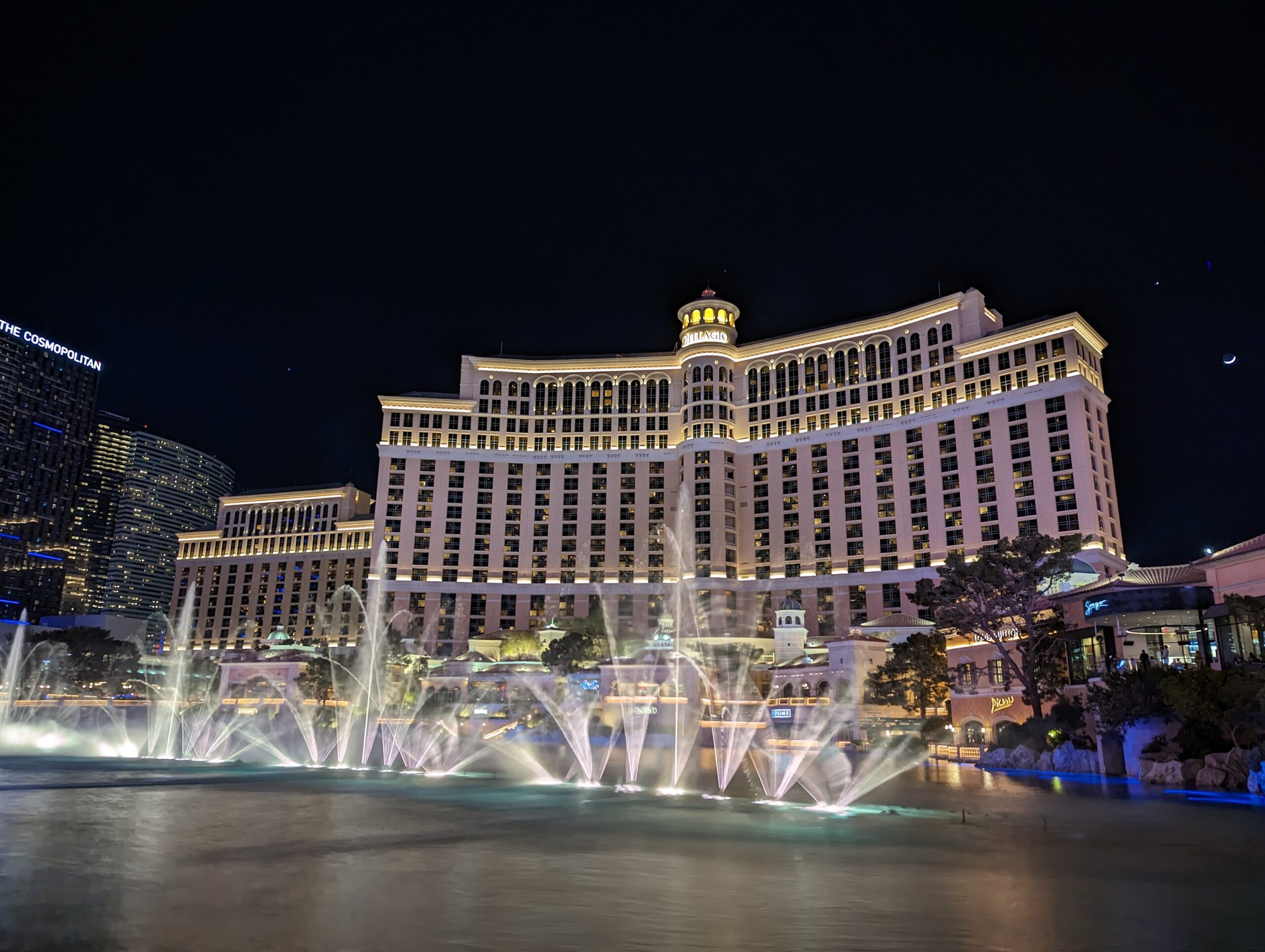 a water fountains in front of a large building with Bellagio in the background