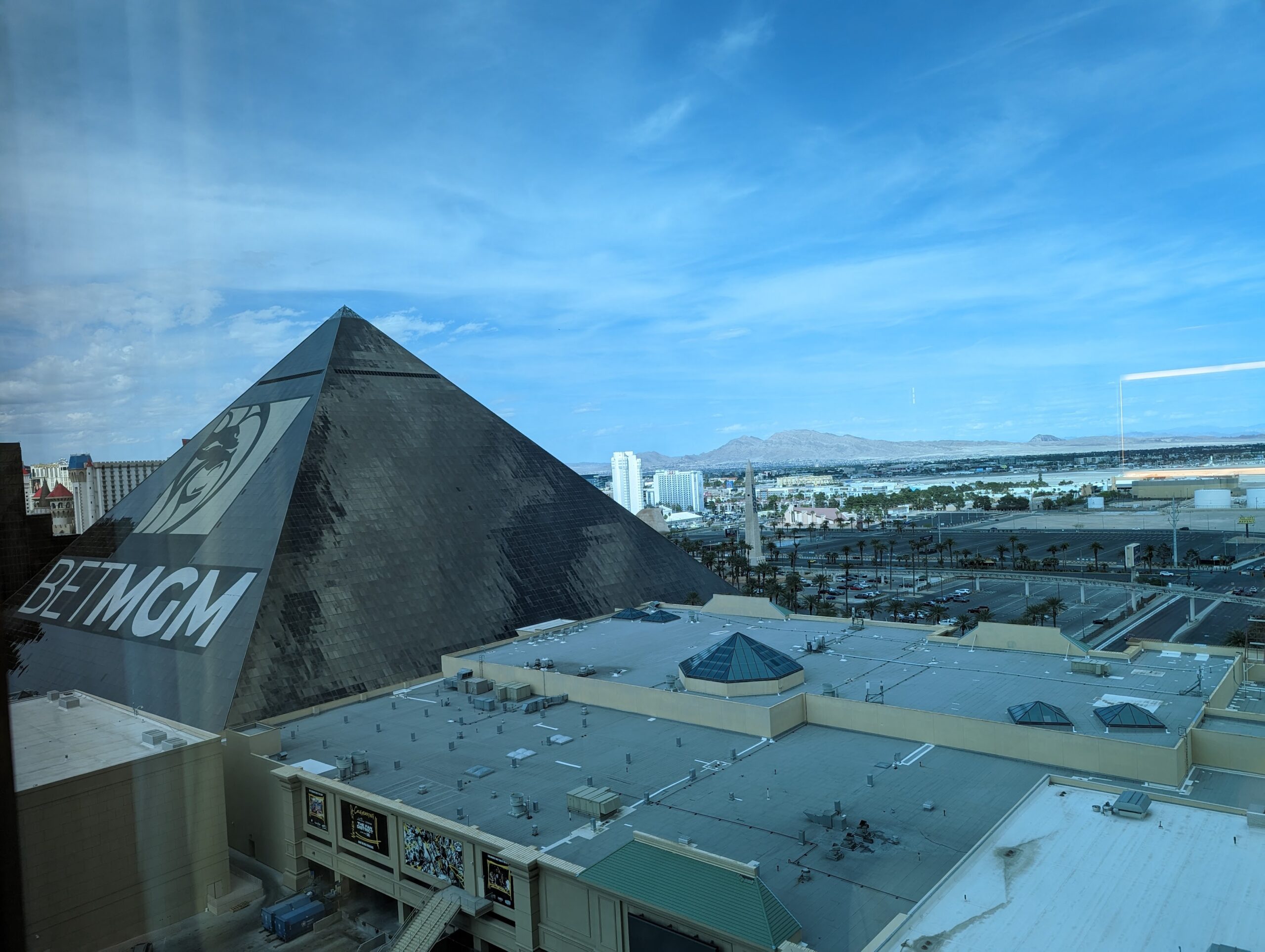 a pyramid shaped building with a city in the background