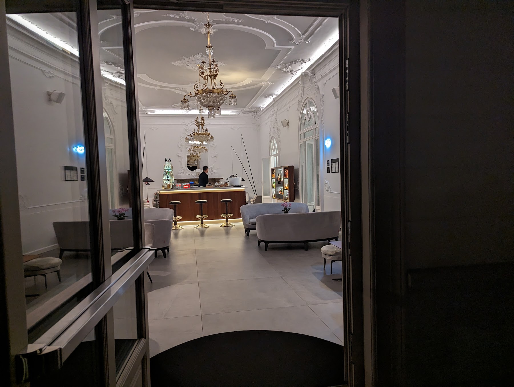 a room with a reception desk and chandeliers