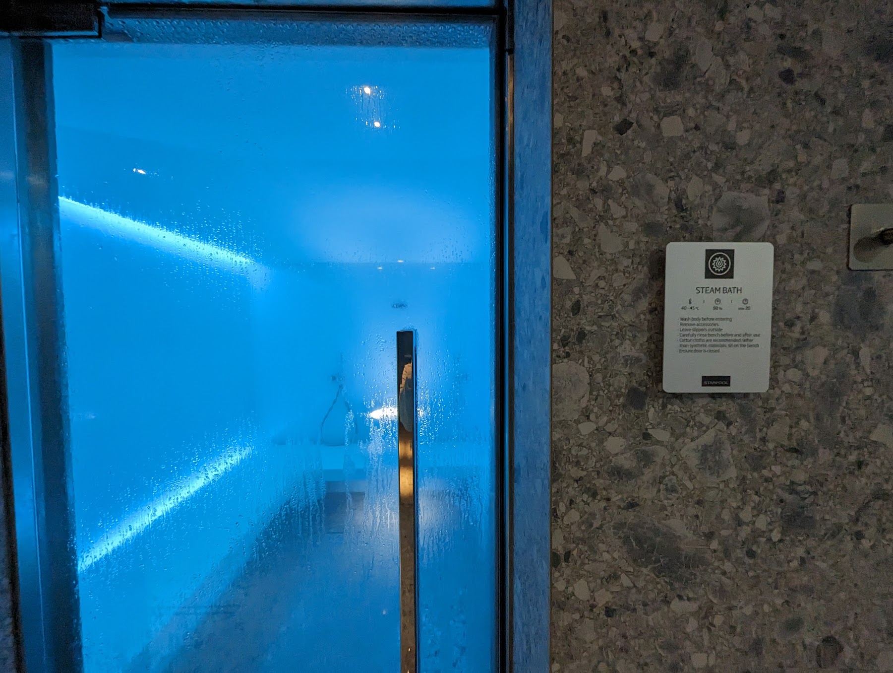 a blue light on a glass door